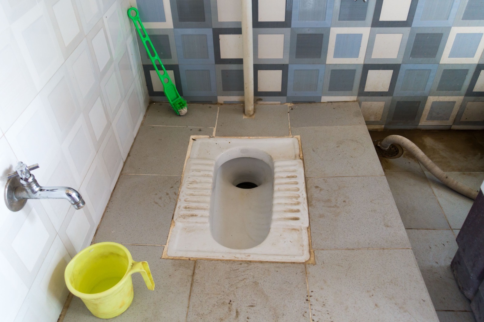 Squat toilet area needing deep clean