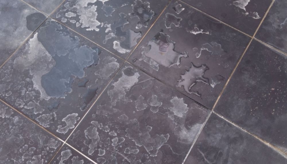 Dirty stained floor tiles before cleaning